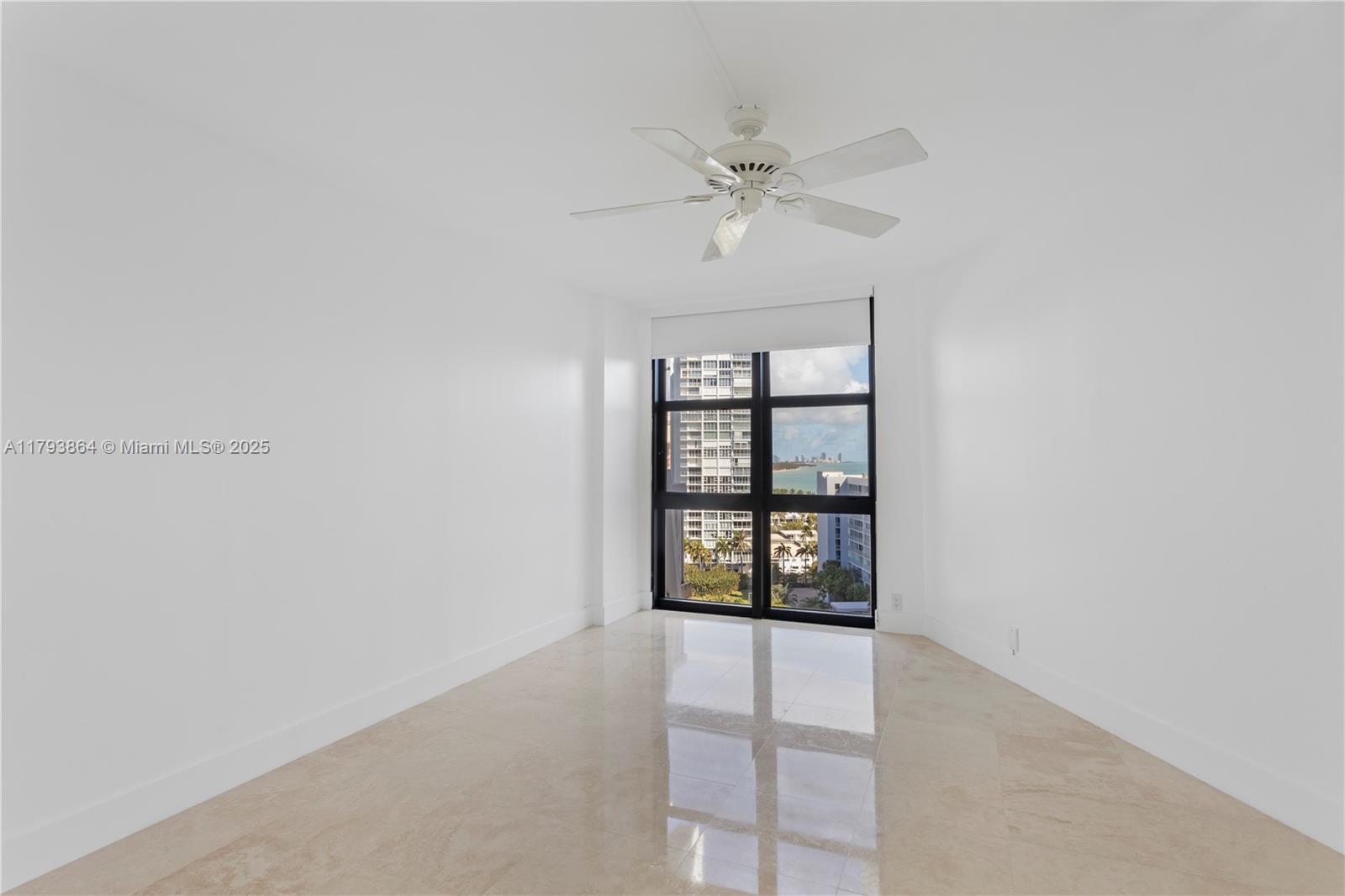 1121 Crandon Boulevard, Unit E1204 Key Biscayne, FL 33149 - Photo 10 of 21 an empty room with windows and fan