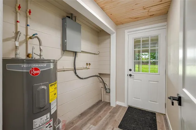 an aerial view of ocean and residential houses with outdoor space