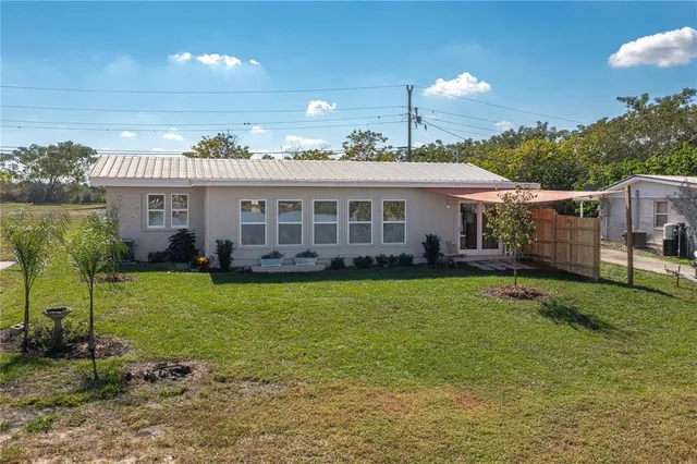 a view of a big room with wooden cabinet and windows