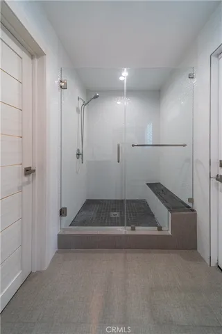 a bathroom with a shower sink and mirror