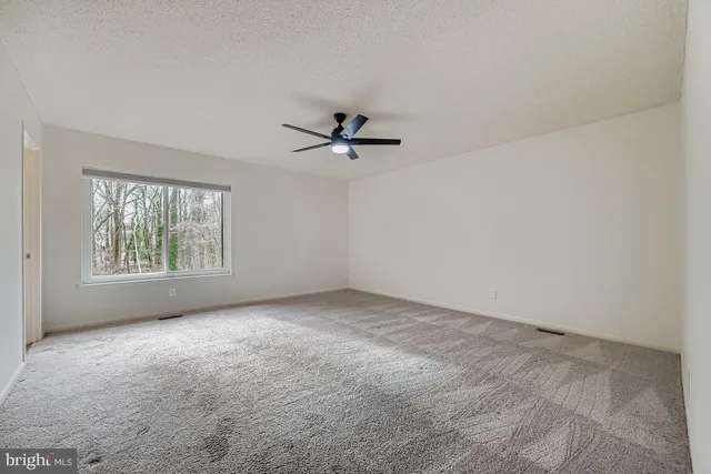 a bathroom with a granite countertop sink a mirror and a bathtub