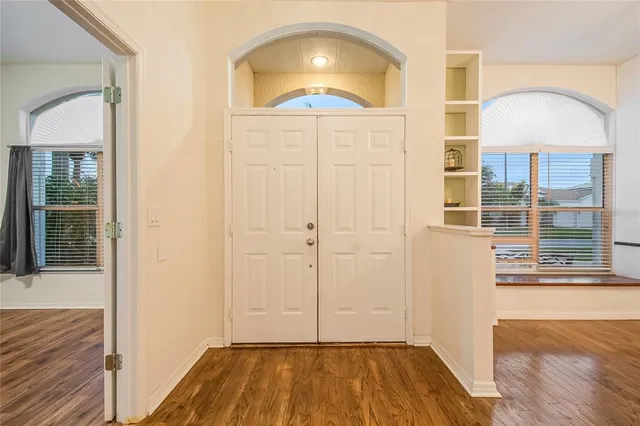 a view of an empty room with wooden floor