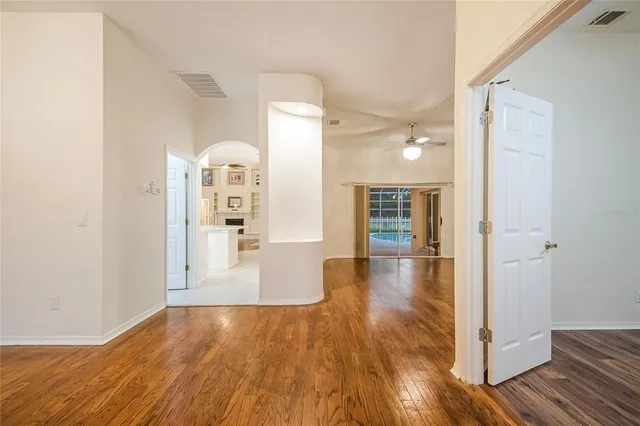 a view of a hallway with wooden floor and staircase