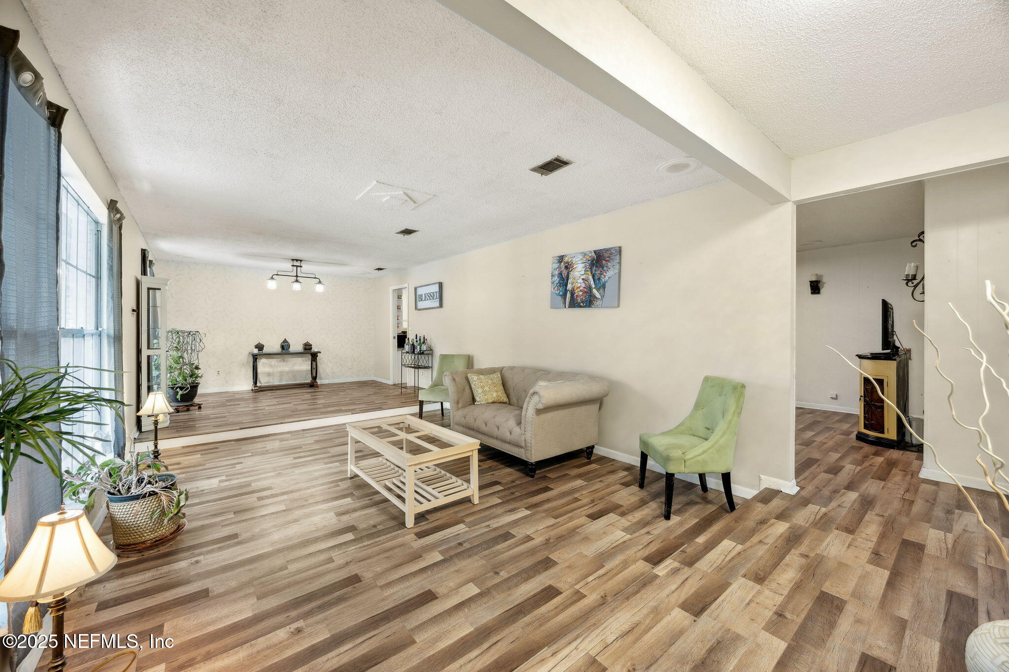 6305 Wuthering Heights Road Jacksonville, FL 32211 - Photo 19 of 52 a living room with furniture and a wooden floor