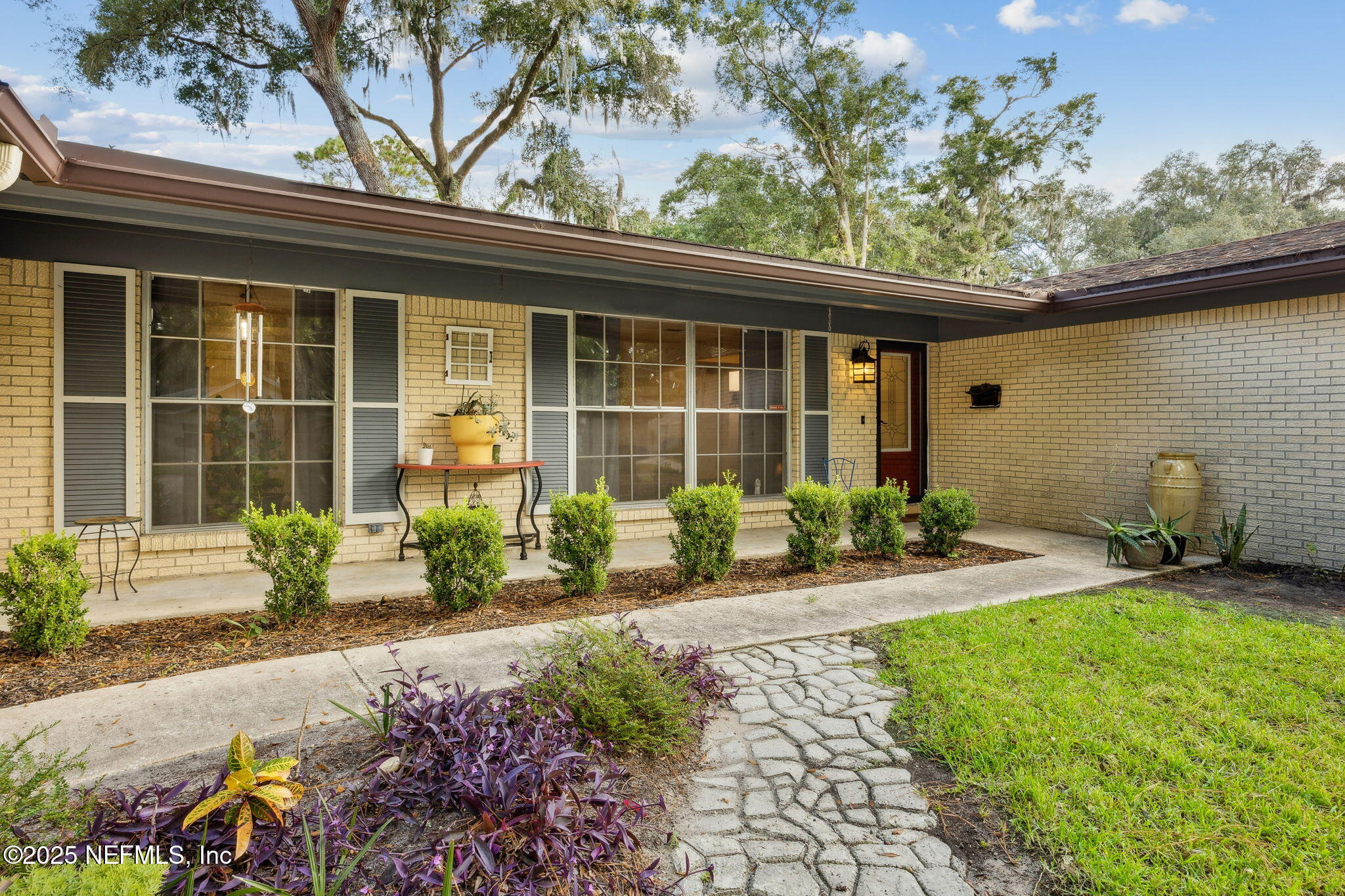 6305 Wuthering Heights Road Jacksonville, FL 32211 - Photo 2 of 52 a front view of a house with garden