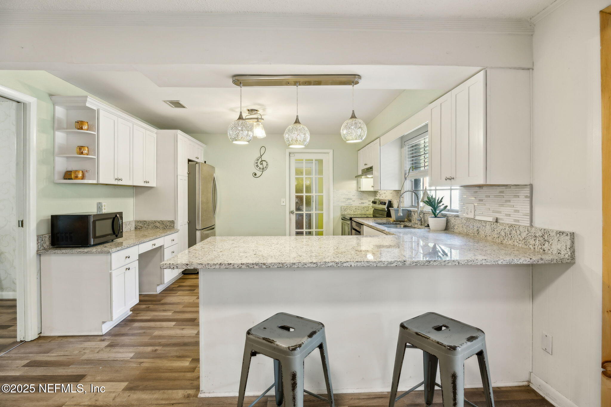 6305 Wuthering Heights Road Jacksonville, FL 32211 - Photo 24 of 53 a kitchen with stainless steel appliances granite countertop a sink and a refrigerator