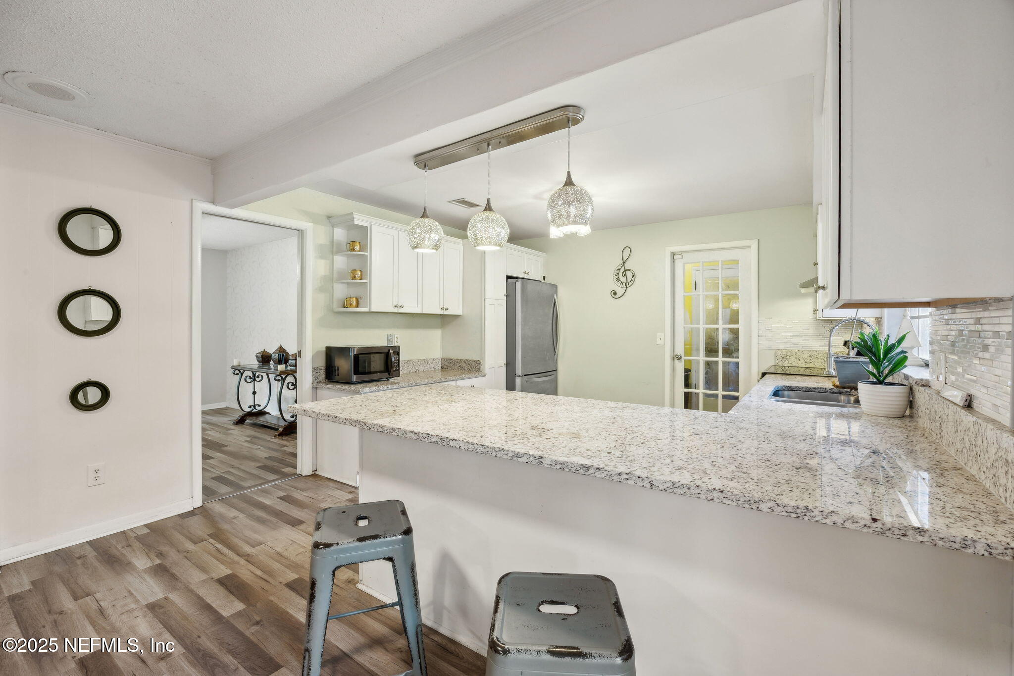 6305 Wuthering Heights Road Jacksonville, FL 32211 - Photo 25 of 53 a large kitchen with kitchen island a sink stainless steel appliances and cabinets