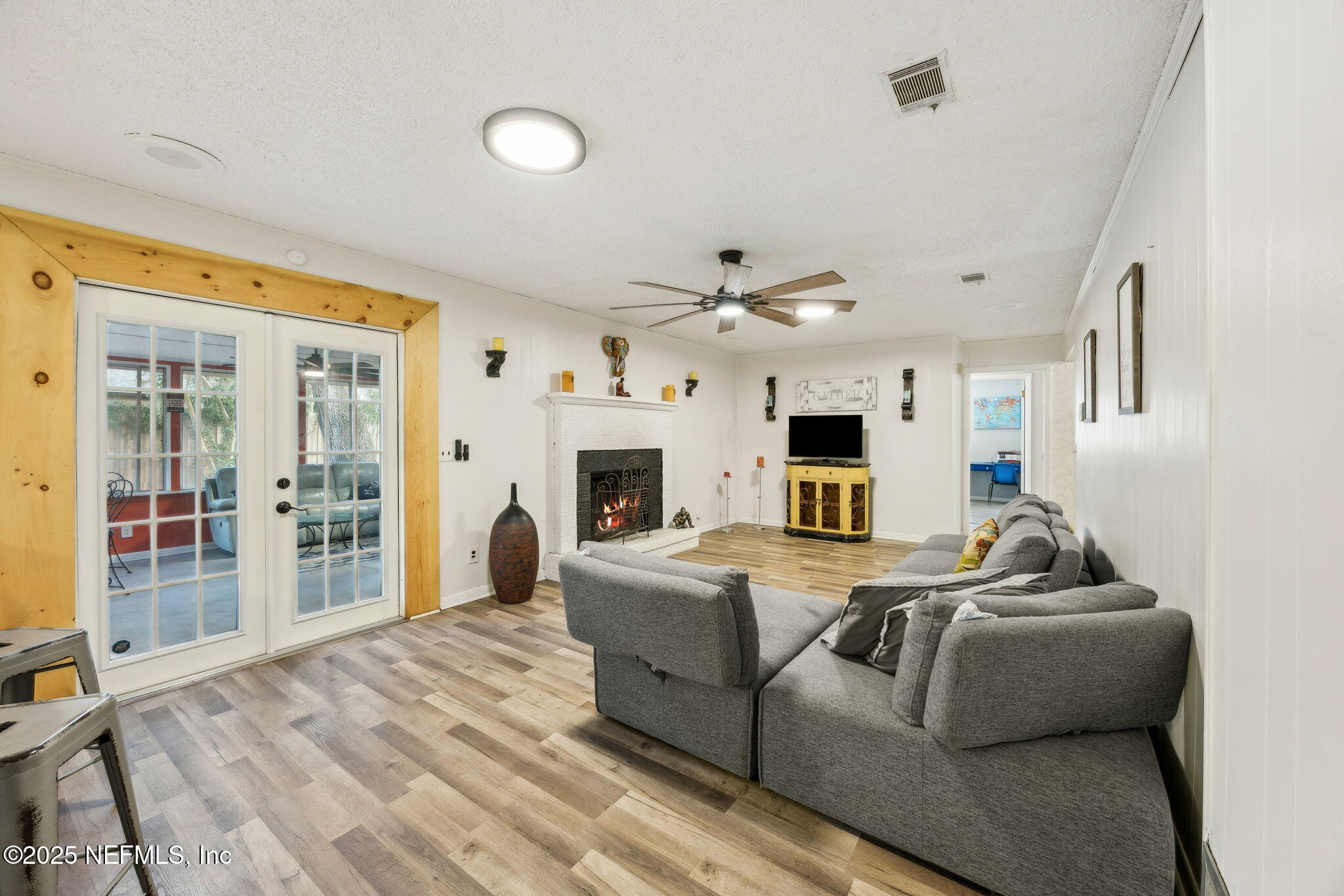 6305 Wuthering Heights Road Jacksonville, FL 32211 - Photo 27 of 52 a living room with furniture a fireplace and a flat screen tv