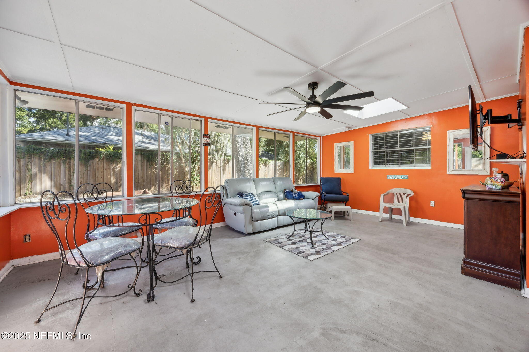 6305 Wuthering Heights Road Jacksonville, FL 32211 - Photo 32 of 52 a living room with furniture a ceiling fan and a large window
