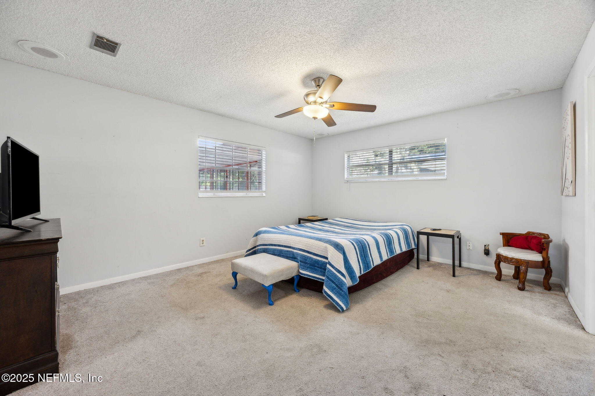 6305 Wuthering Heights Road Jacksonville, FL 32211 - Photo 36 of 52 a bedroom with a bed and a chandelier