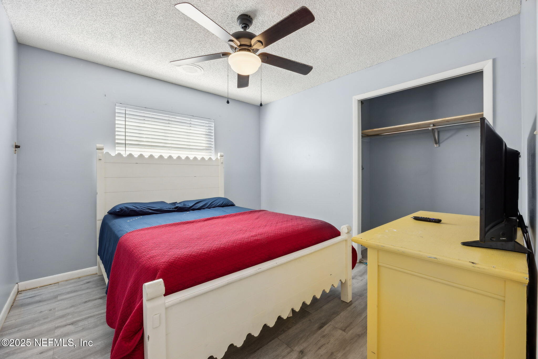 6305 Wuthering Heights Road Jacksonville, FL 32211 - Photo 46 of 53 a bedroom with a bed and a flat screen tv