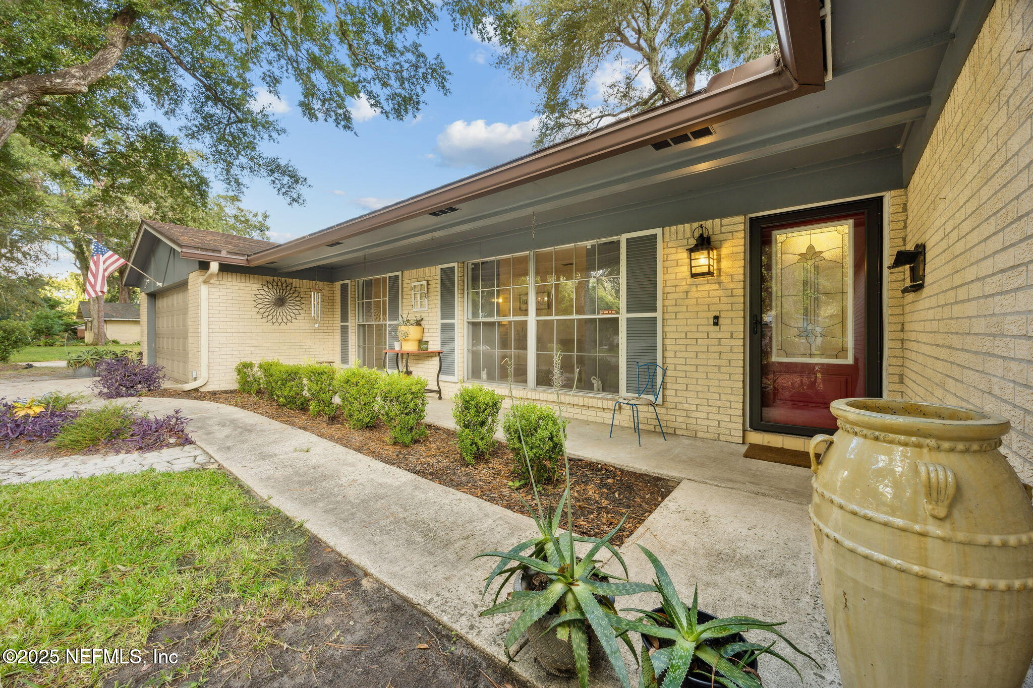6305 Wuthering Heights Road Jacksonville, FL 32211 - Photo 7 of 52 a front view of a house with garden