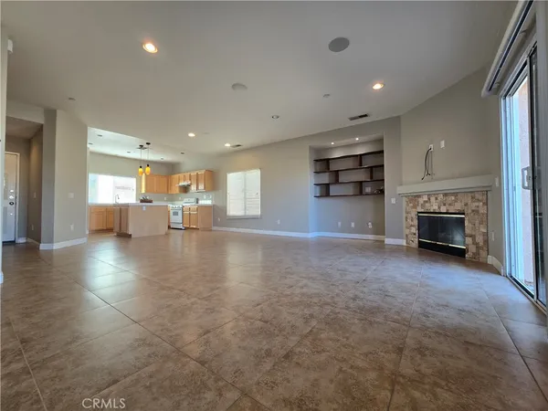 an empty room with furniture and a fireplace