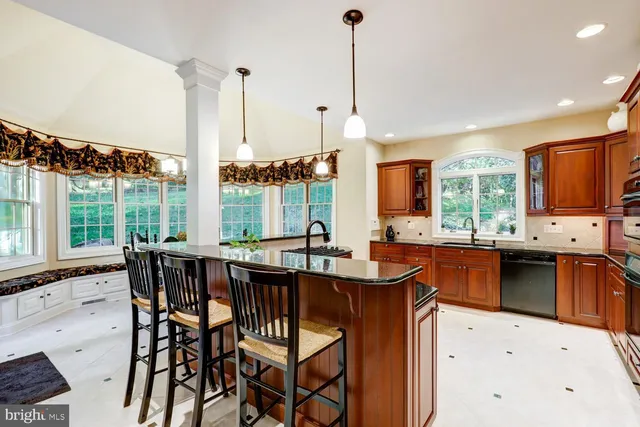 a dining room with wooden floor a chandelier a wooden table and chairs