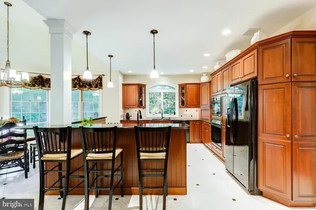 a living room with fireplace furniture and a large window