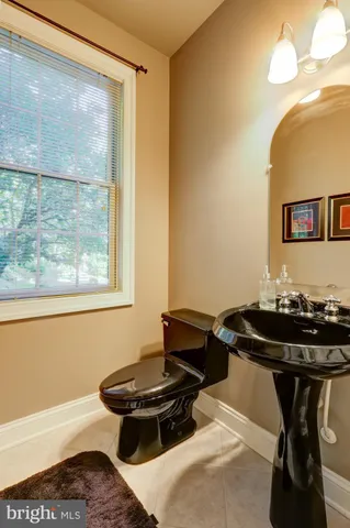 a living room with furniture a fireplace and a large window