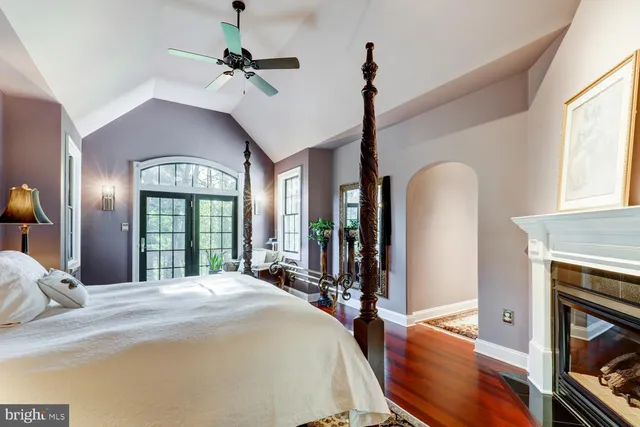 a living room with furniture a fireplace and a large window