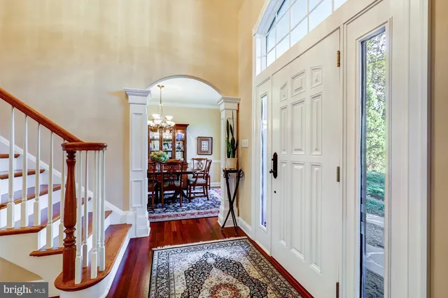 a view of a dining room with furniture wooden floor and chandelier
