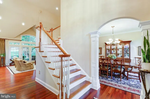 a view of a dining room with furniture a chandelier and wooden floor