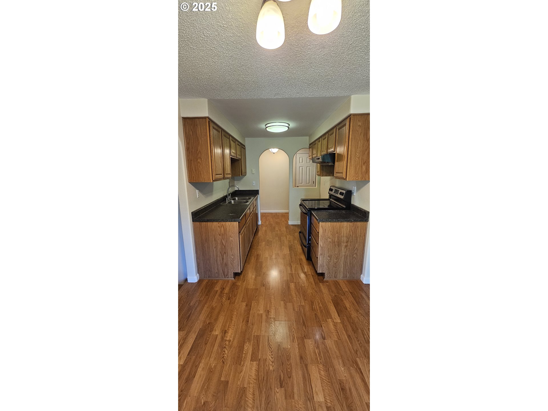 1132 Pleasant Street Springfield, OR 97477 - Photo 3 of 25 a view of a hallway with wooden floor