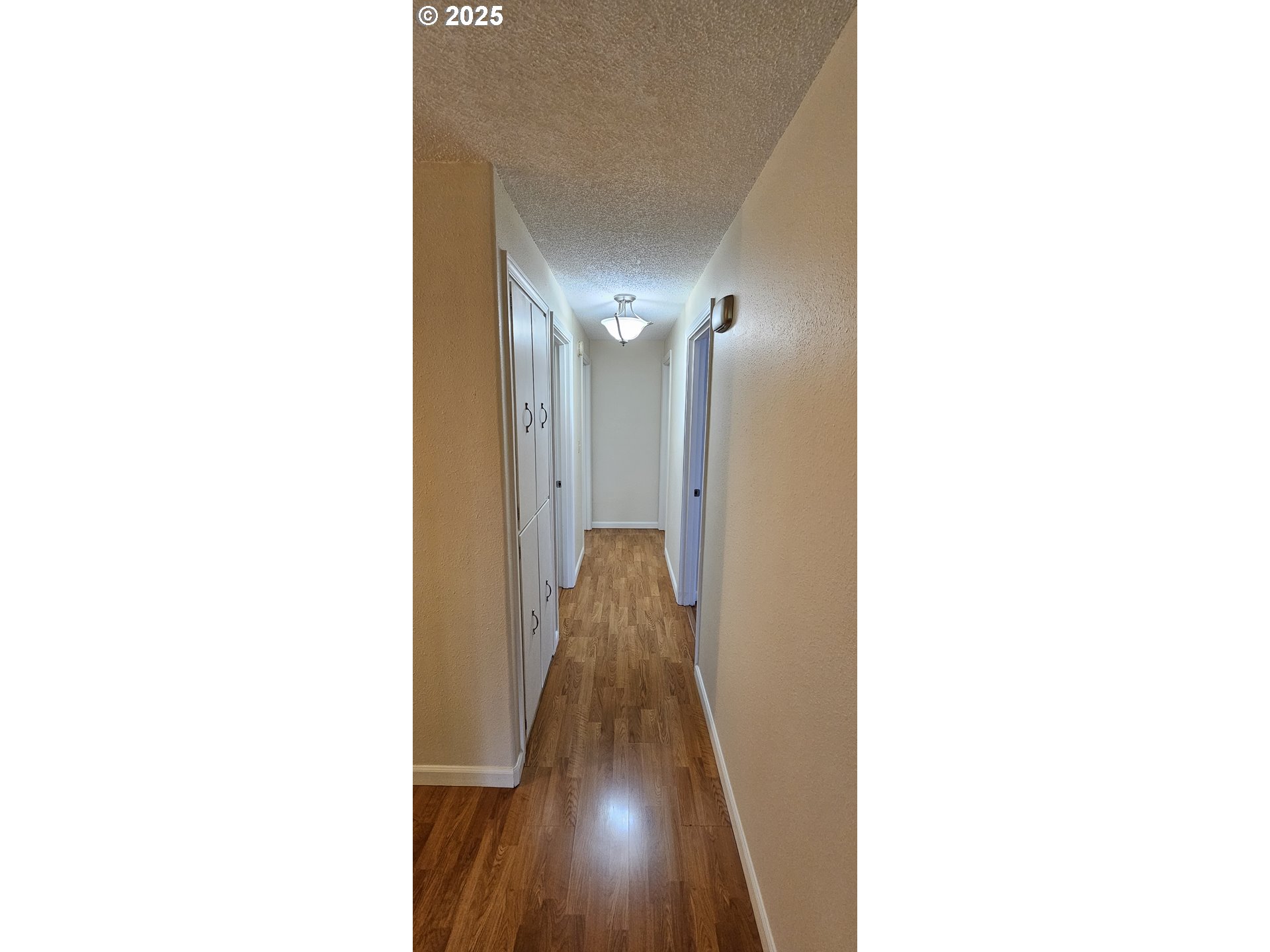 1132 Pleasant Street Springfield, OR 97477 - Photo 8 of 25 a view of a hallway with wooden floor
