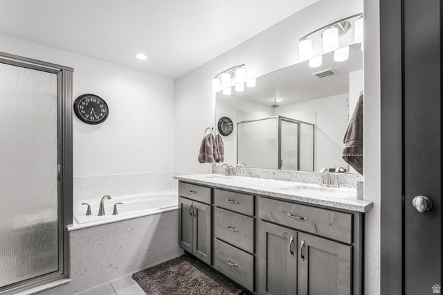 313 Old Maple Road South Weber, UT 84405 - Photo 15 of 35 Double vanity with undermount sinks, stone countertop, and contemporary lighting fixtures