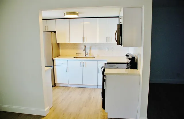 a utility room with cabinets washer and dryer