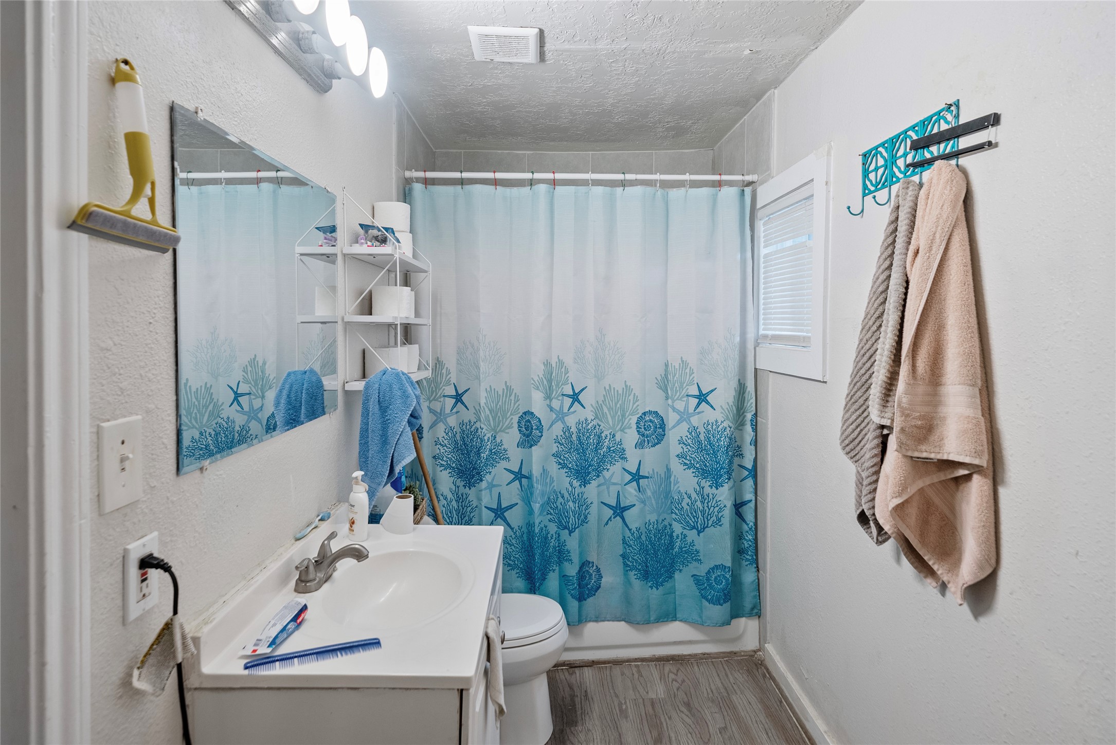 7938 Kerr Street, Unit 6 Houston, TX 77029 - Photo 8 of 18 a bathroom with a shower curtain and a sink