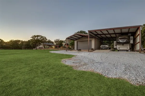 an aerial view of a house with yard swimming pool and outdoor seating