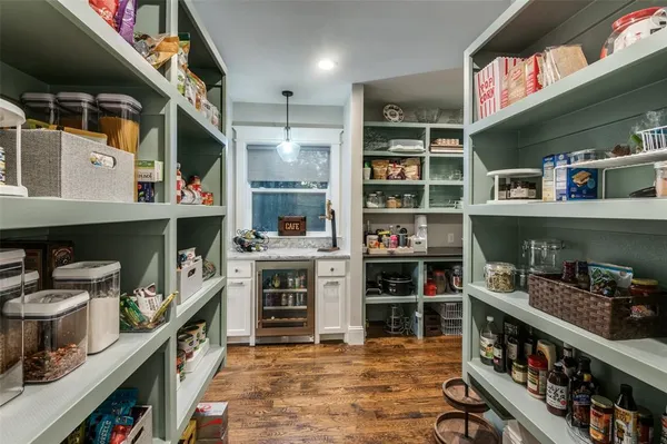 a kitchen with a table chairs sink and cabinets