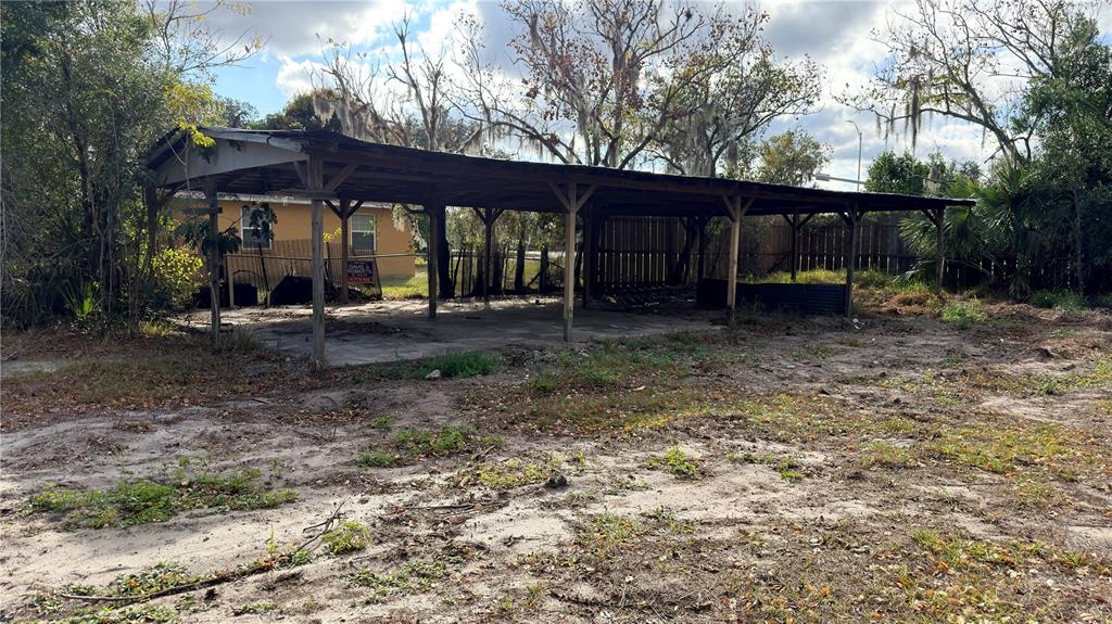 11 7th Street Southeast Fort Meade, FL 33841 - Photo 13 of 19 a backyard of a house with barbeque oven table and chairs