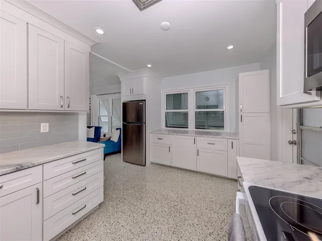a kitchen with refrigerator and window