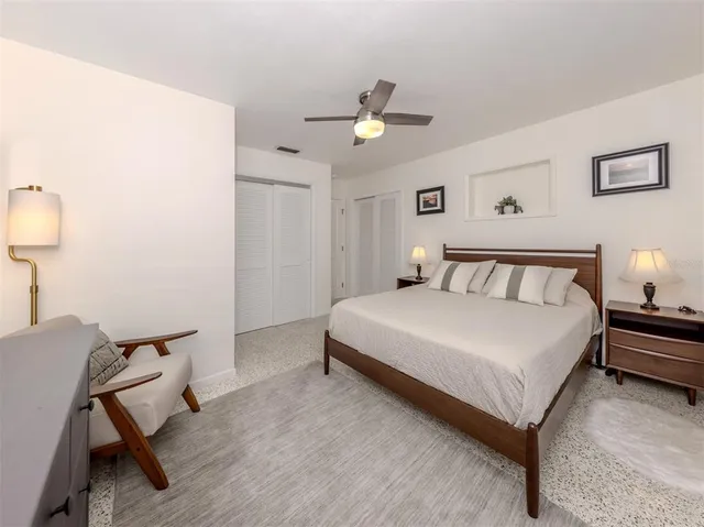 a bedroom with a bed and a lamp with window