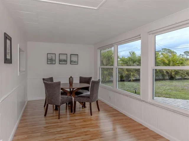 a view of a dining room with furniture and wooden floor