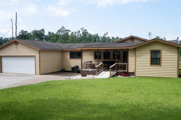 a front view of a house with patio and yard