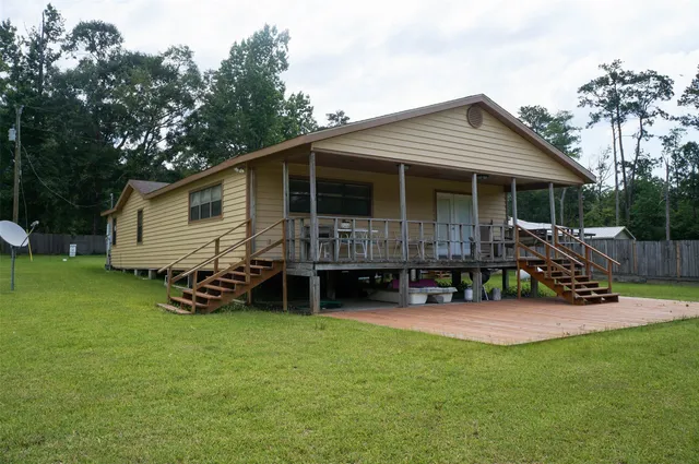 a view of a house with a yard and sitting area