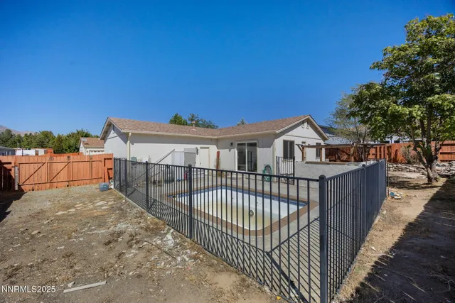 a view of a wrought iron fences in front of house
