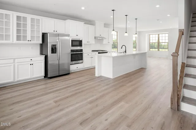 a view of kitchen with cabinets and wooden floor