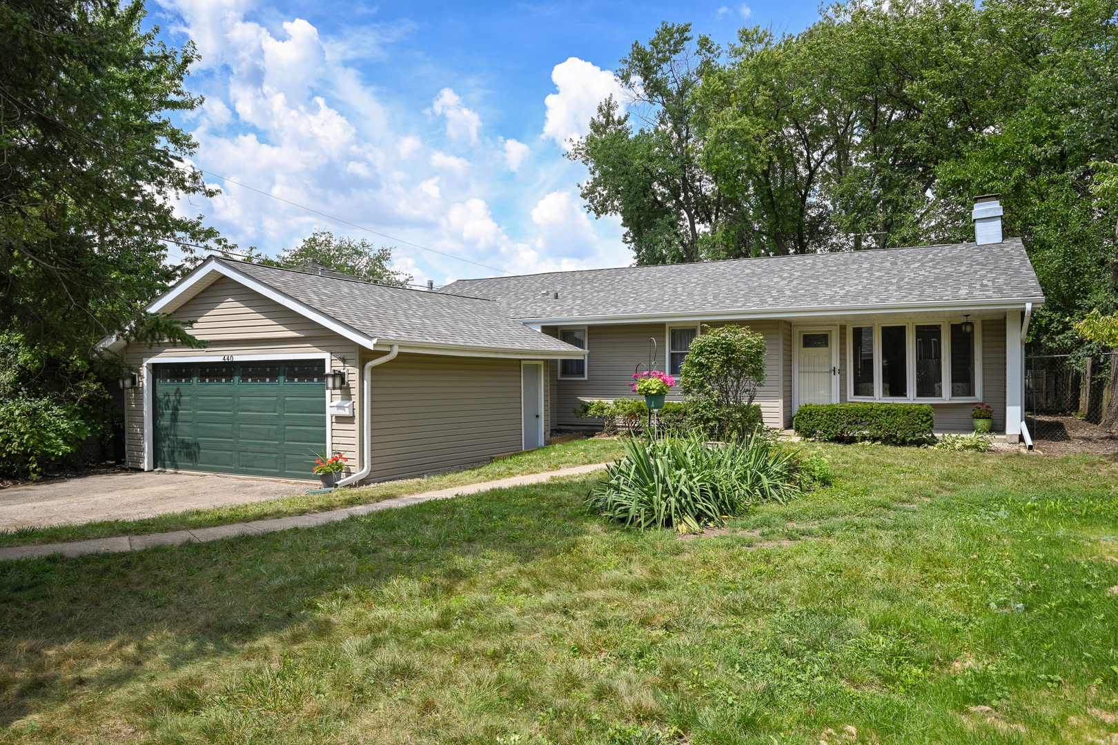 a front view of house with yard and green space