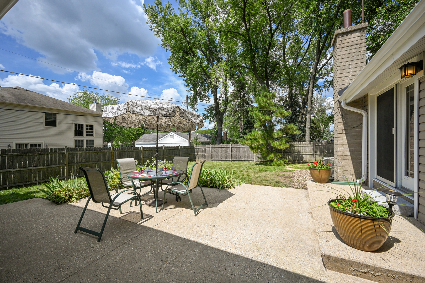 440 West Harrison Road Lombard, IL 60148 - Photo 22 of 26 a view of a patio with table and chairs and potted plants