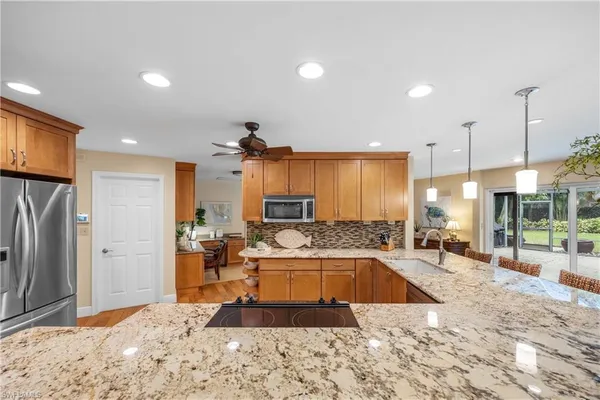 a large kitchen with kitchen island a sink stove and refrigerator