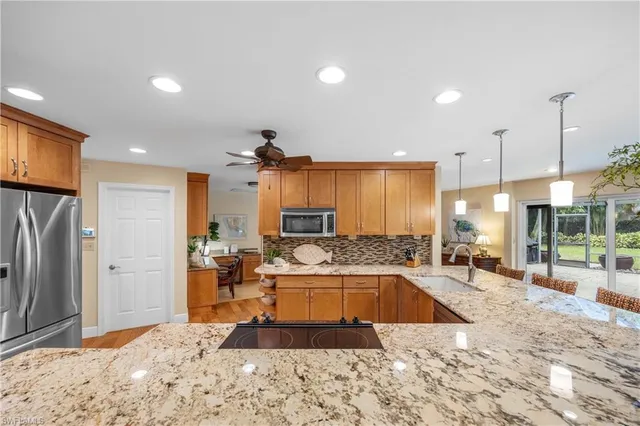 a large kitchen with kitchen island a sink stove and refrigerator