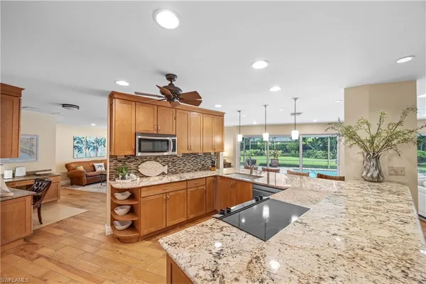 a kitchen with stainless steel appliances granite countertop a sink and a stove