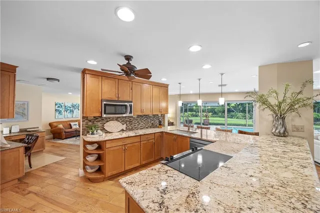 a kitchen with stainless steel appliances granite countertop a sink and a stove