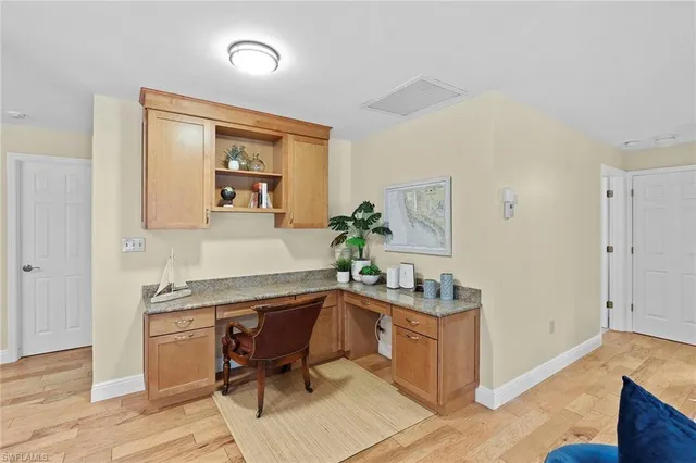 a view of a workspace with furniture and wooden floor