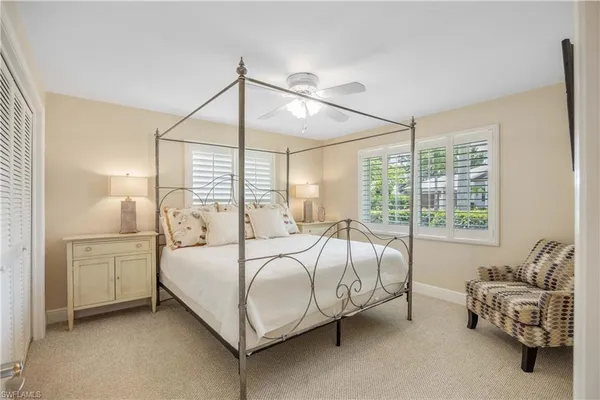a bed sitting in a bedroom next to a window