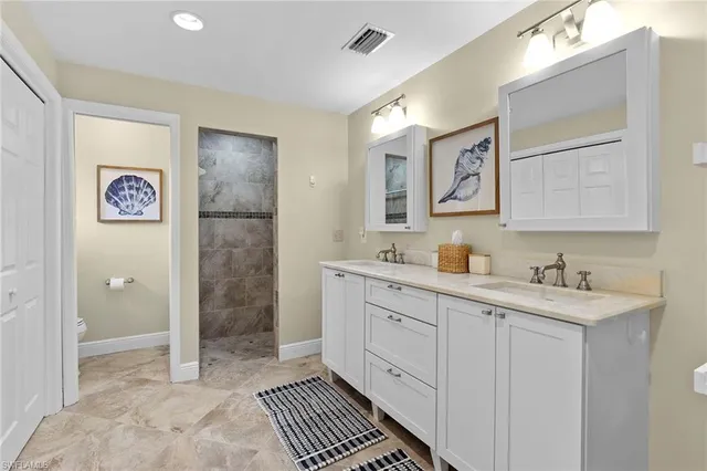 a spacious bathroom with a shower sink and mirror
