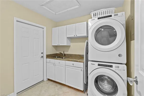 a utility room with sink dryer and washer
