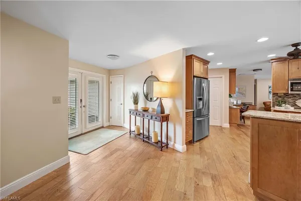 a view of a kitchen with furniture and wooden floor