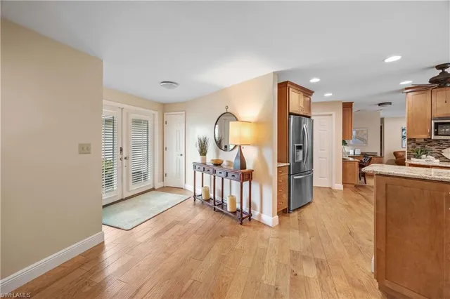 a view of a kitchen with furniture and wooden floor